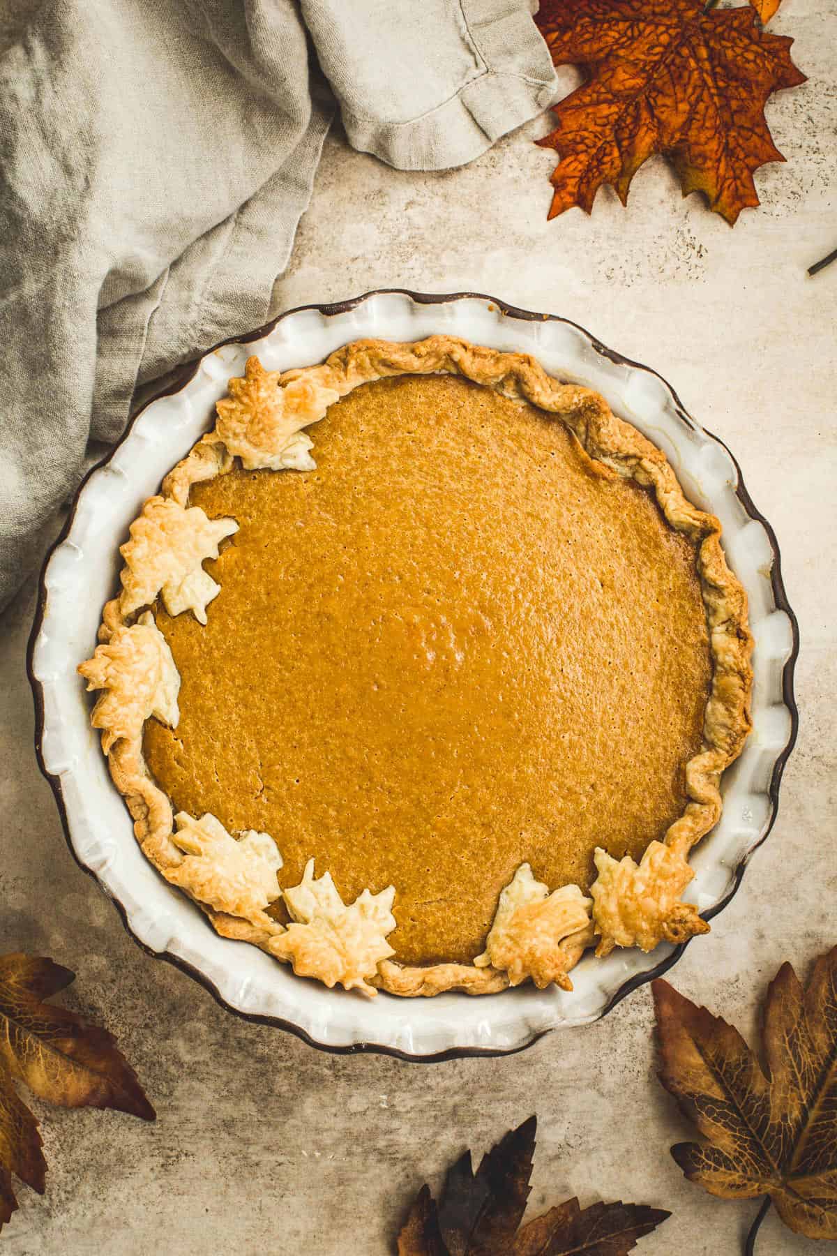 Maple pumpkin pie with a leaf covered crust.