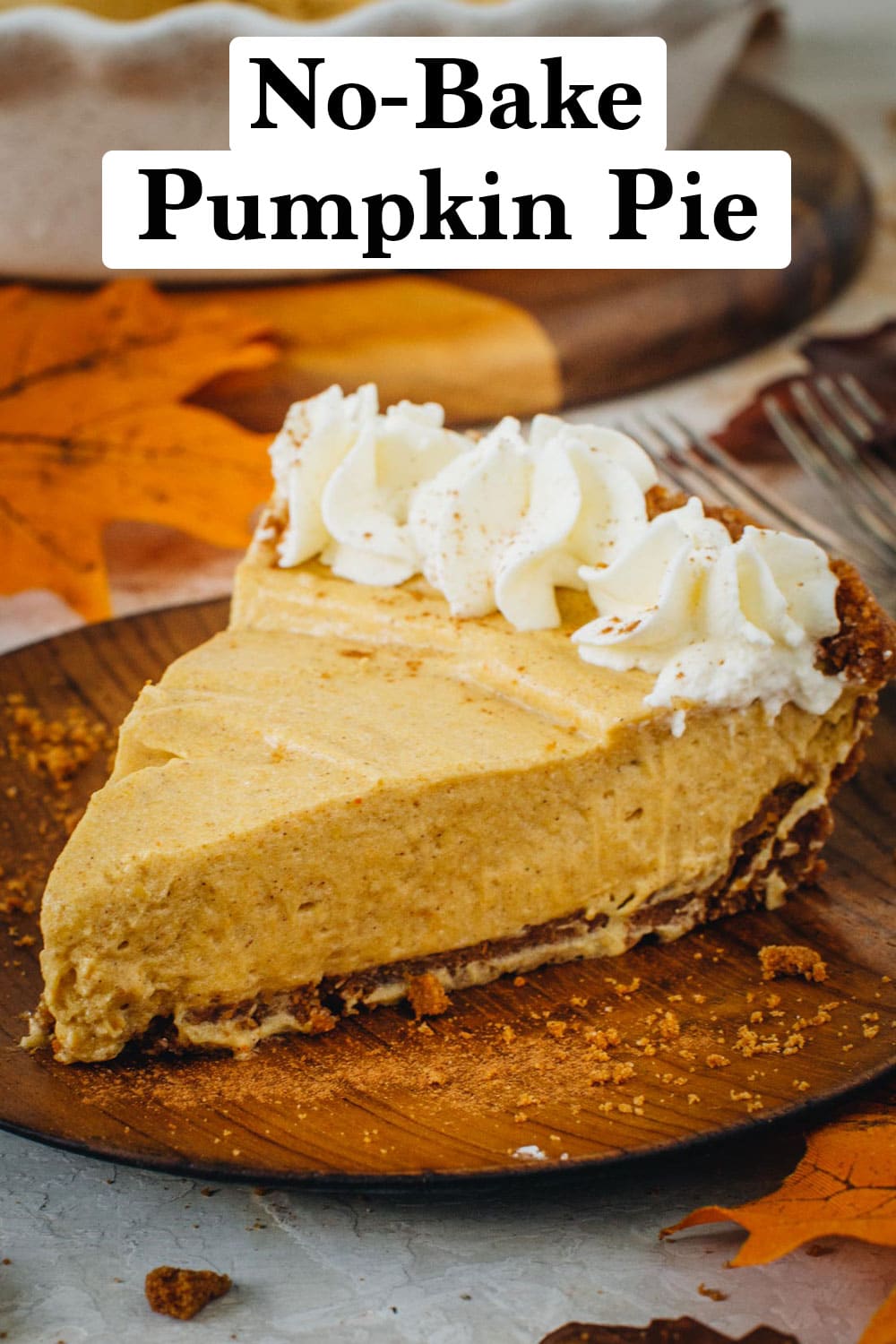 No-Bake Pumpkin Pie slice with whipped topping on a wooden plate.
