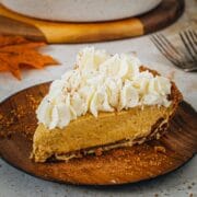 No-bake pumpkin pie slice topped with whipped cream and cinnamon.