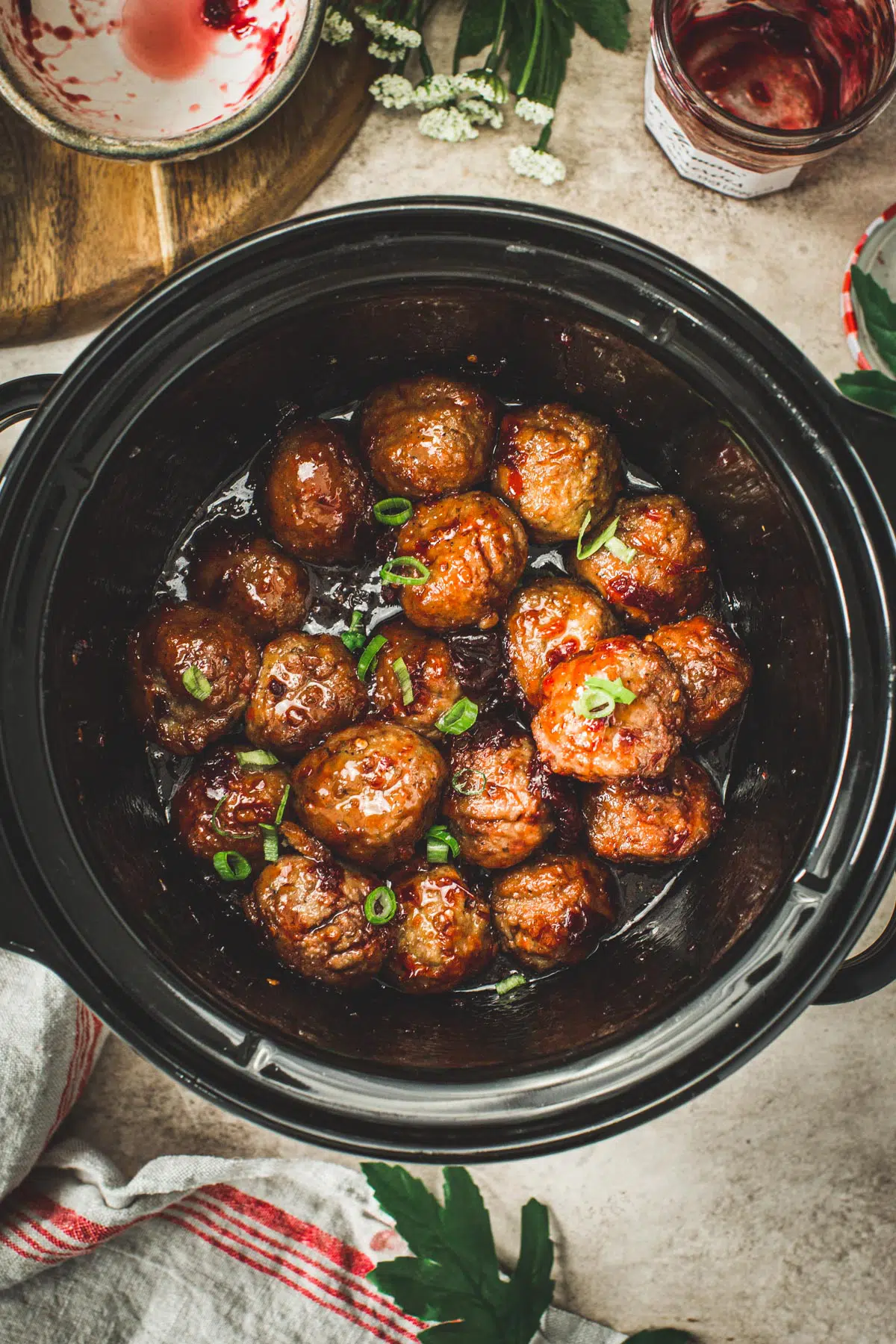 Meatballs with grape jelly and chili sauce in a crockpot.