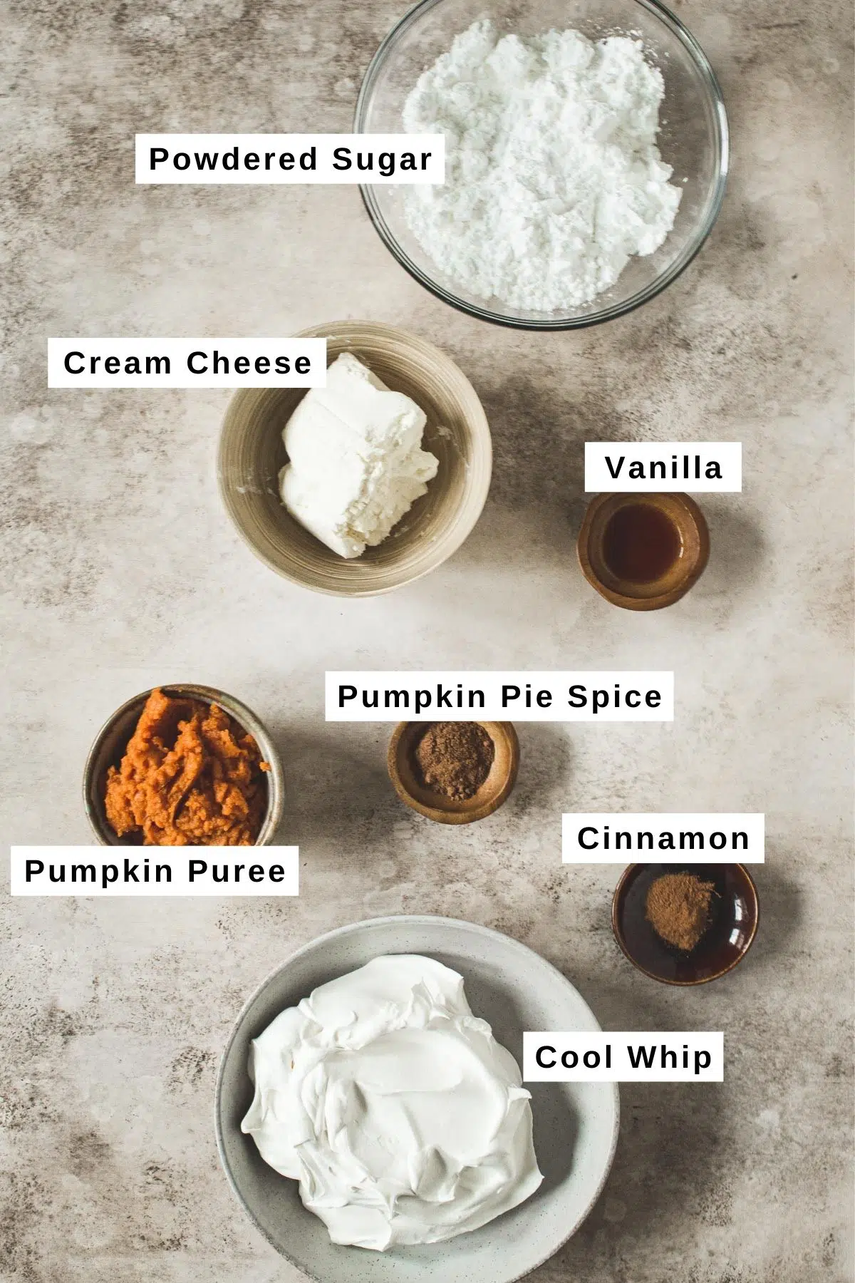 Pumpkin pie cheesecake dip ingredients in different bowls.