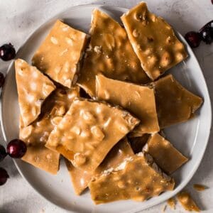 Microwave peanut brittle on a white plate.