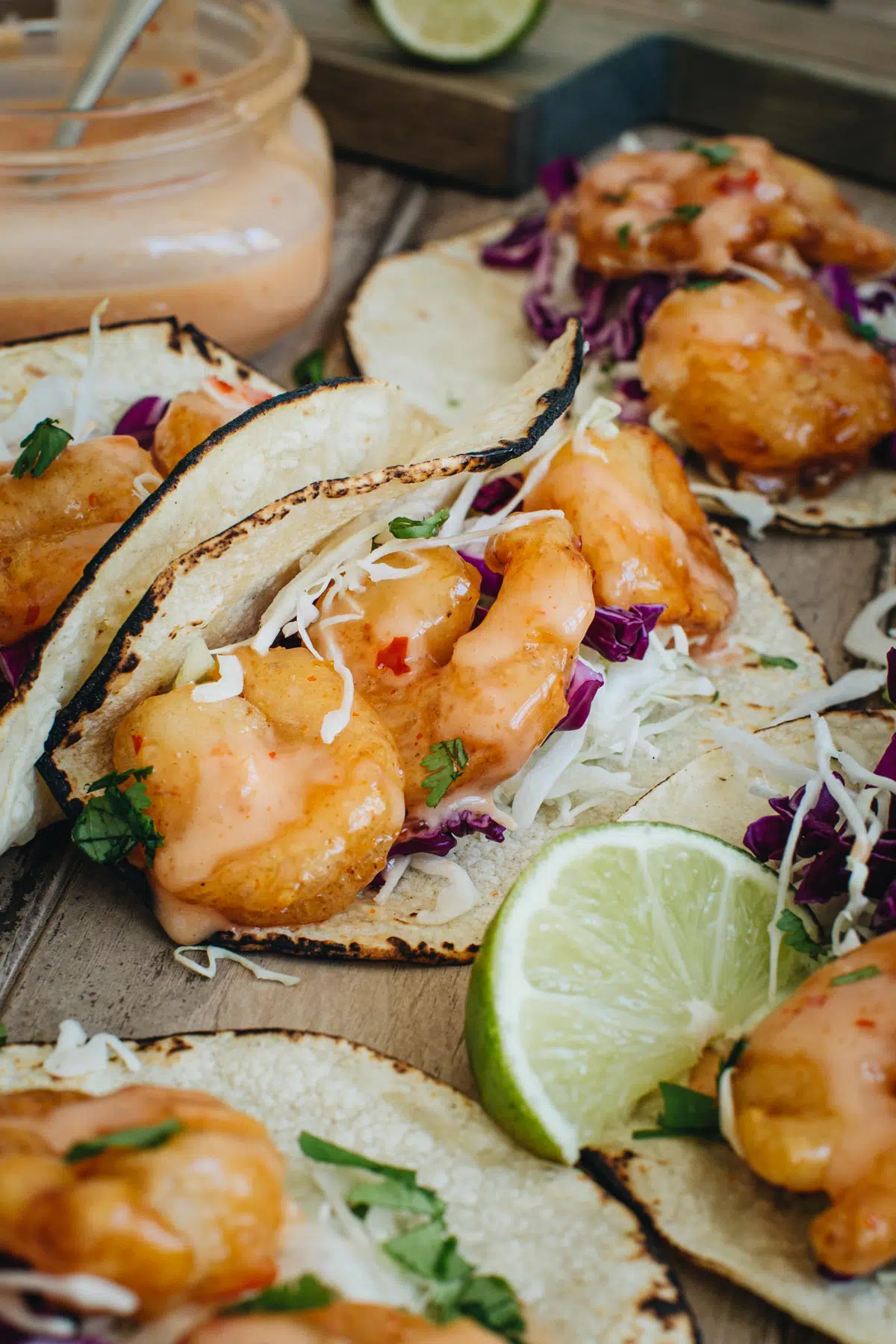 Fried shrimp tacos with lime wedge next to it.