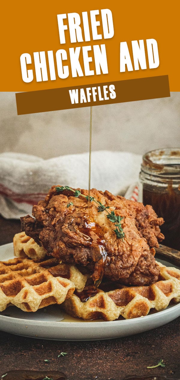 Southern fried chicken and waffles with syrup drizzling on top.