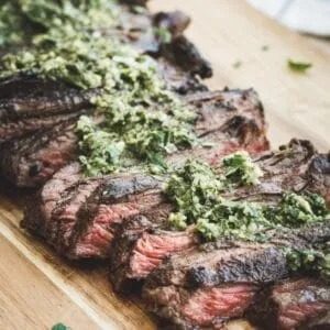 Sliced churrasco with chimichurri on top.