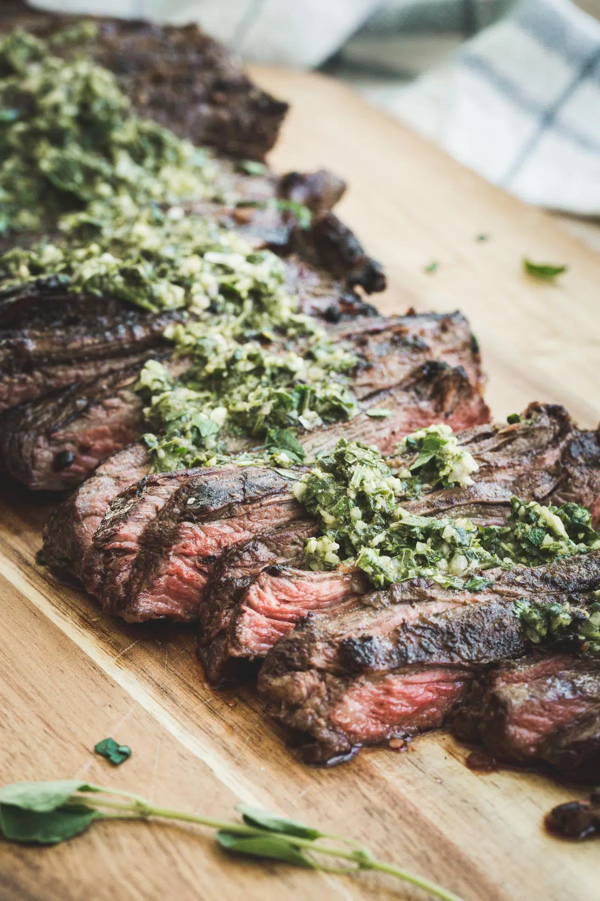 Sliced churrasco with chimichurri on top.