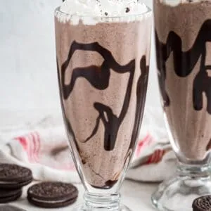 Oreo milkshake topped with whipped cream and crushed Oreos.