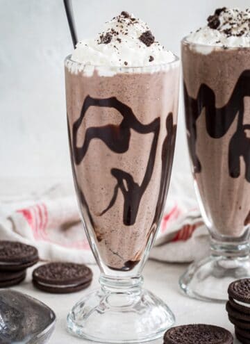 Oreo milkshake topped with whipped cream and crushed Oreos.