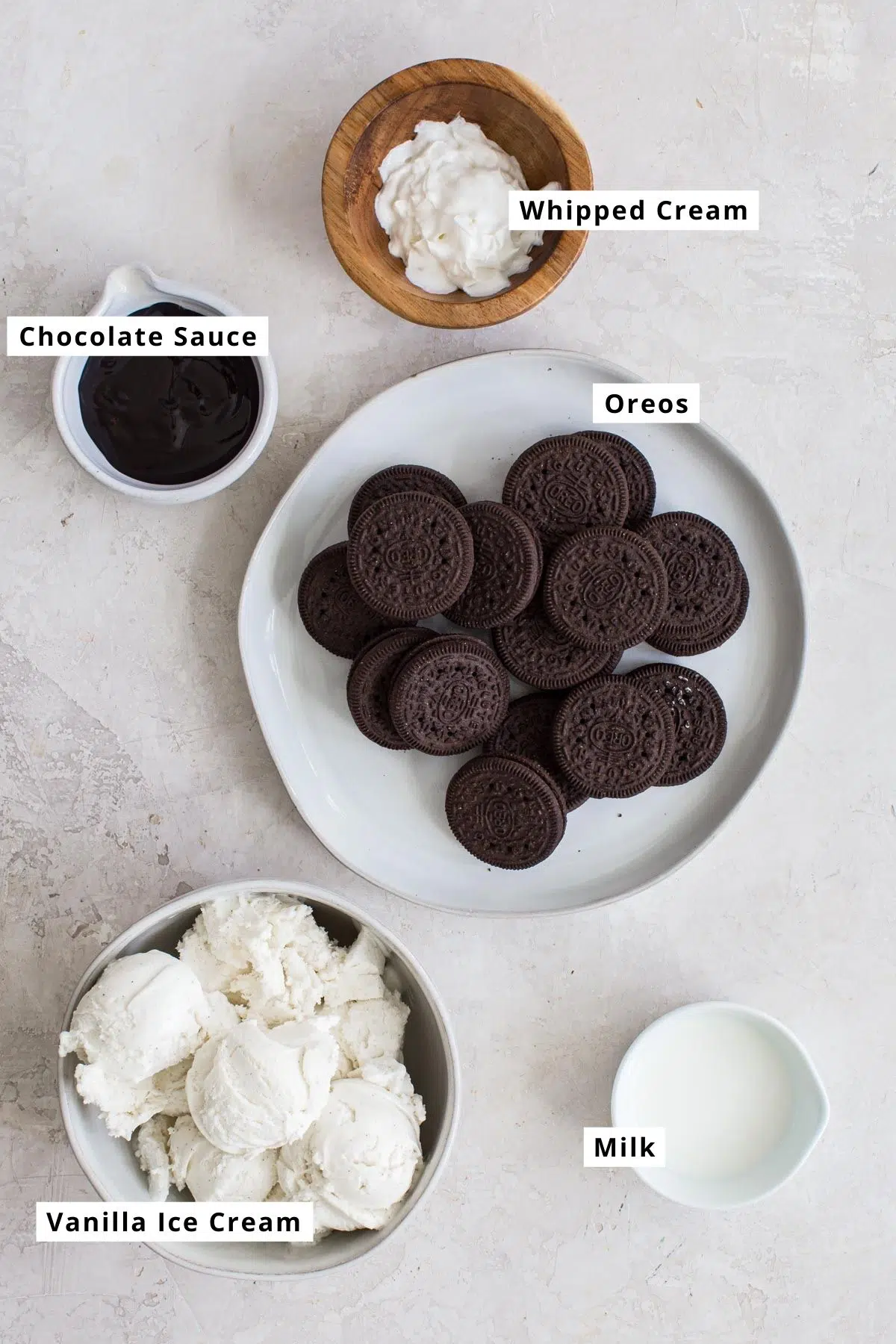 Oreo milkshake ingredients in various bowls.