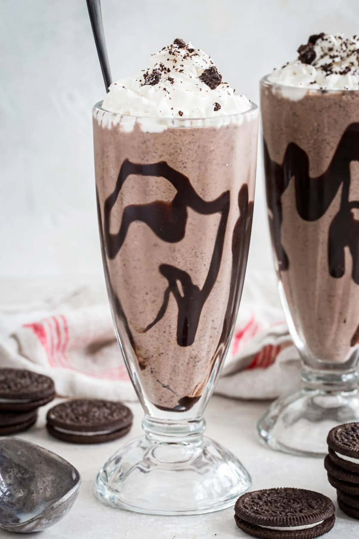 Oreo milkshake topped with whipped cream and crushed Oreos.