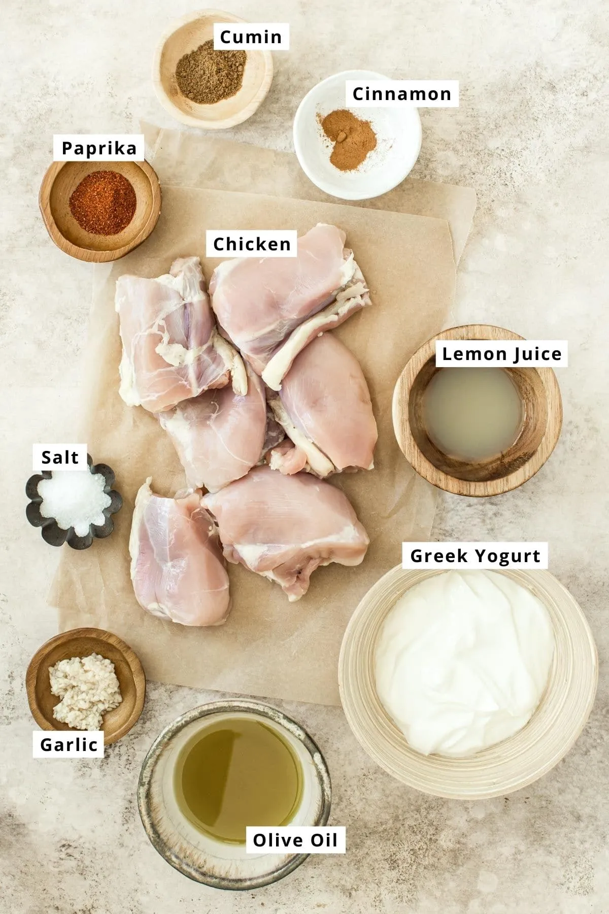 Yogurt marinated chicken ingredients in various bowls.