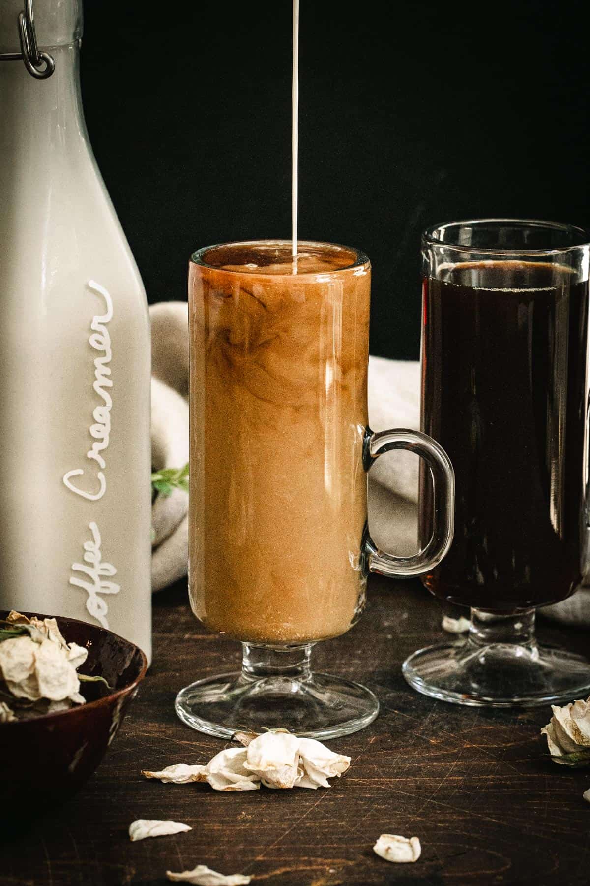Homemade vegan coffee creamer being poured into a coffee mug filled with coffee.