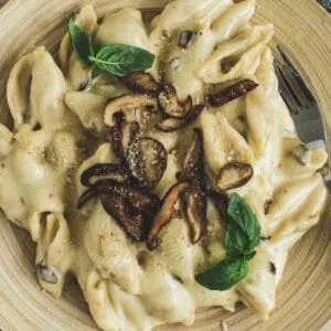 Truffle mac and cheese topped with mushrooms and basil.