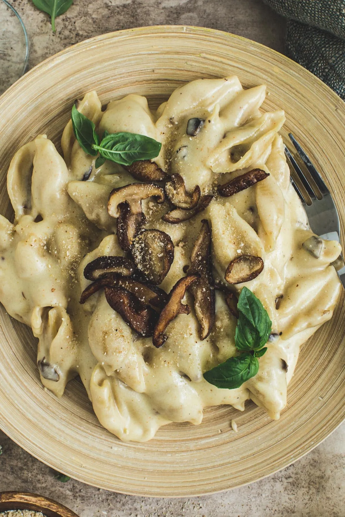 Truffle mac and cheese topped with mushrooms, breadcrumbs, and fresh basil.