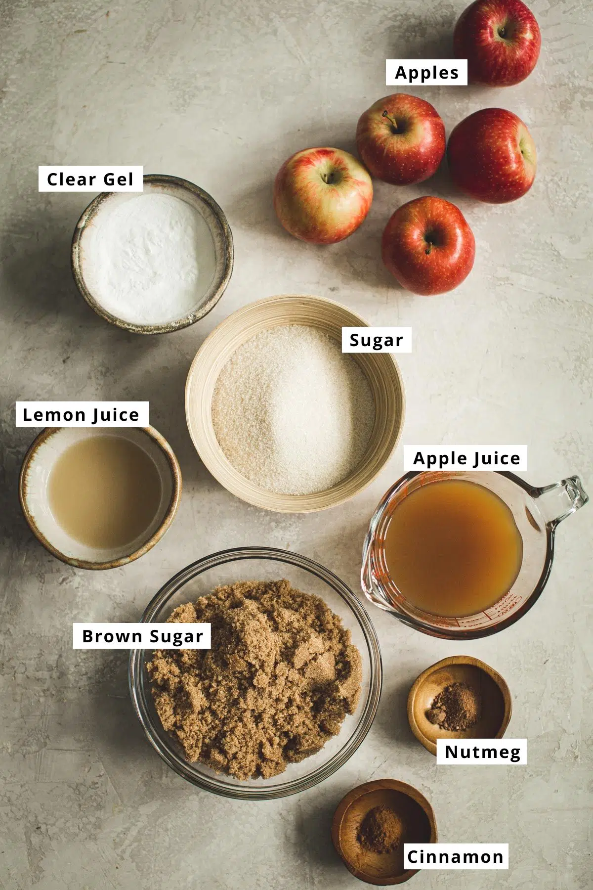 Homemade apple pie ingredients in various bowls.