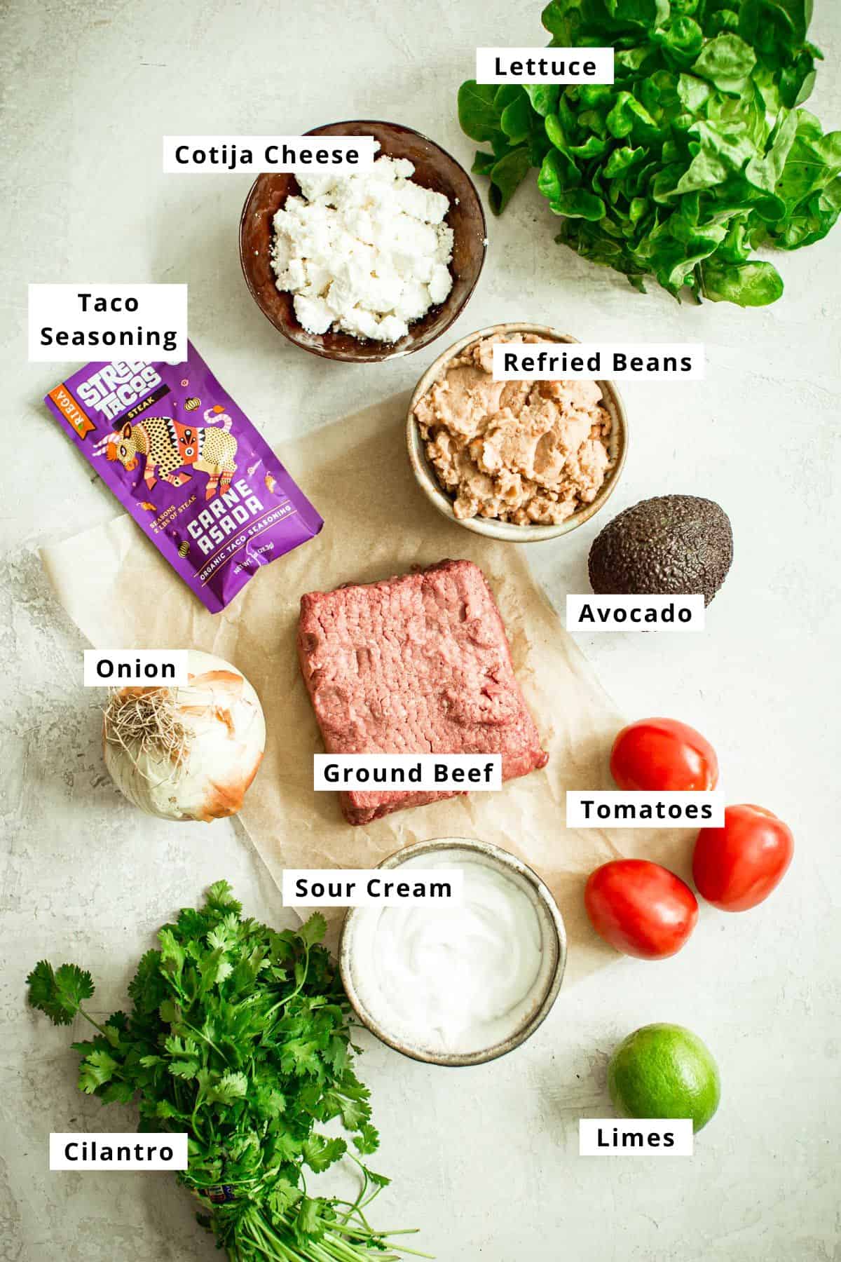 Ground feef tostadas recipe ingredients in various bowls.