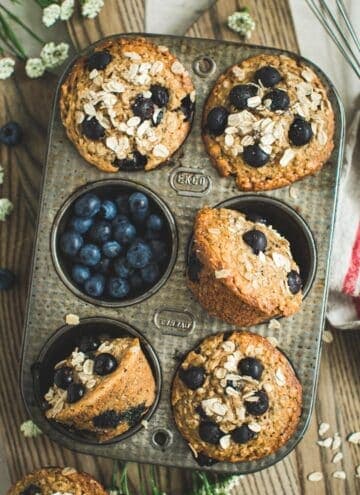 Blueberry oatmeal muffins in a recipe tin.