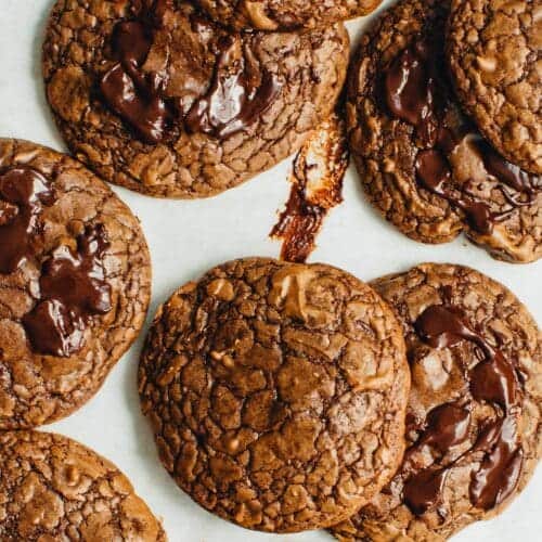 Brownie mix cookies stacked on a sheet pan.