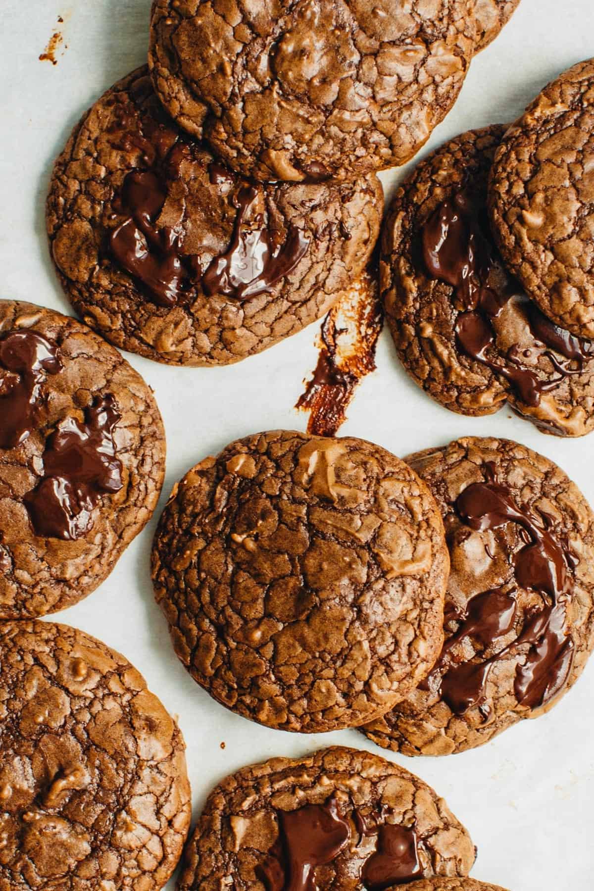 Brownie mix cookies stacked on a sheet pan.