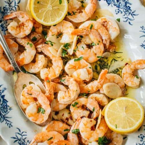 Garlic shrimp scampi on a floral platter.