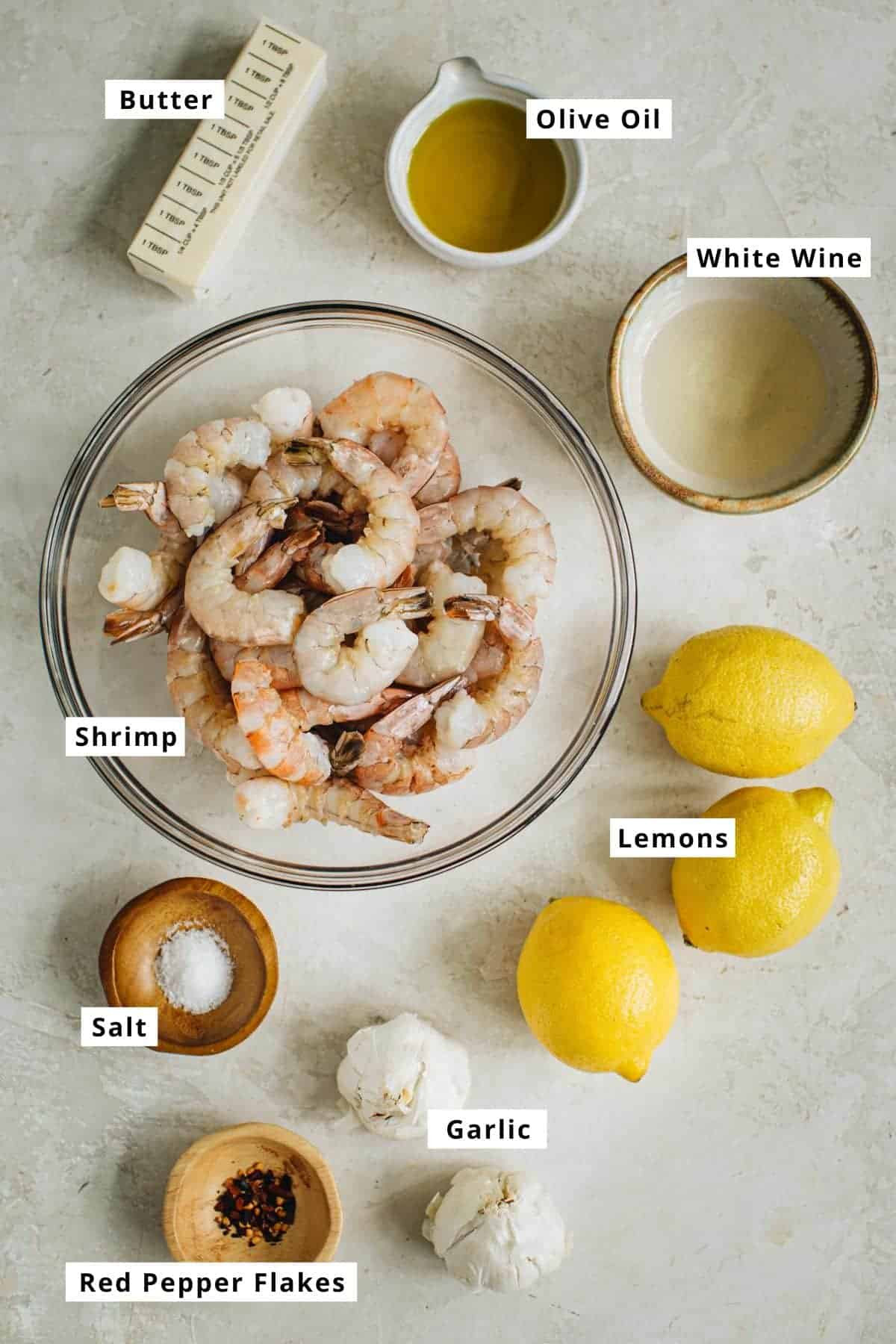 Garlic shrimp scampi ingredients in various bowls.