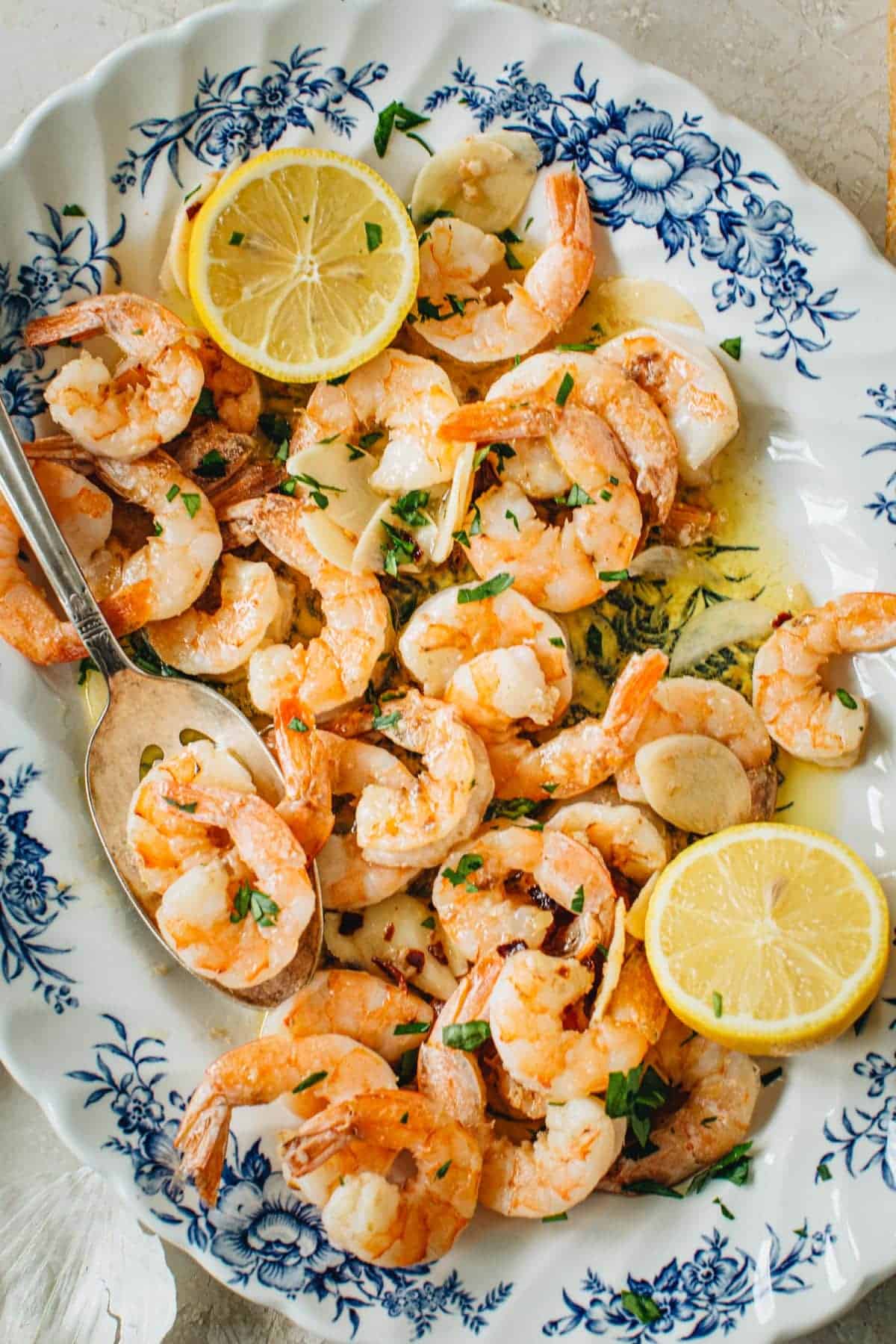 Garlic shrimp scampi on a floral platter.