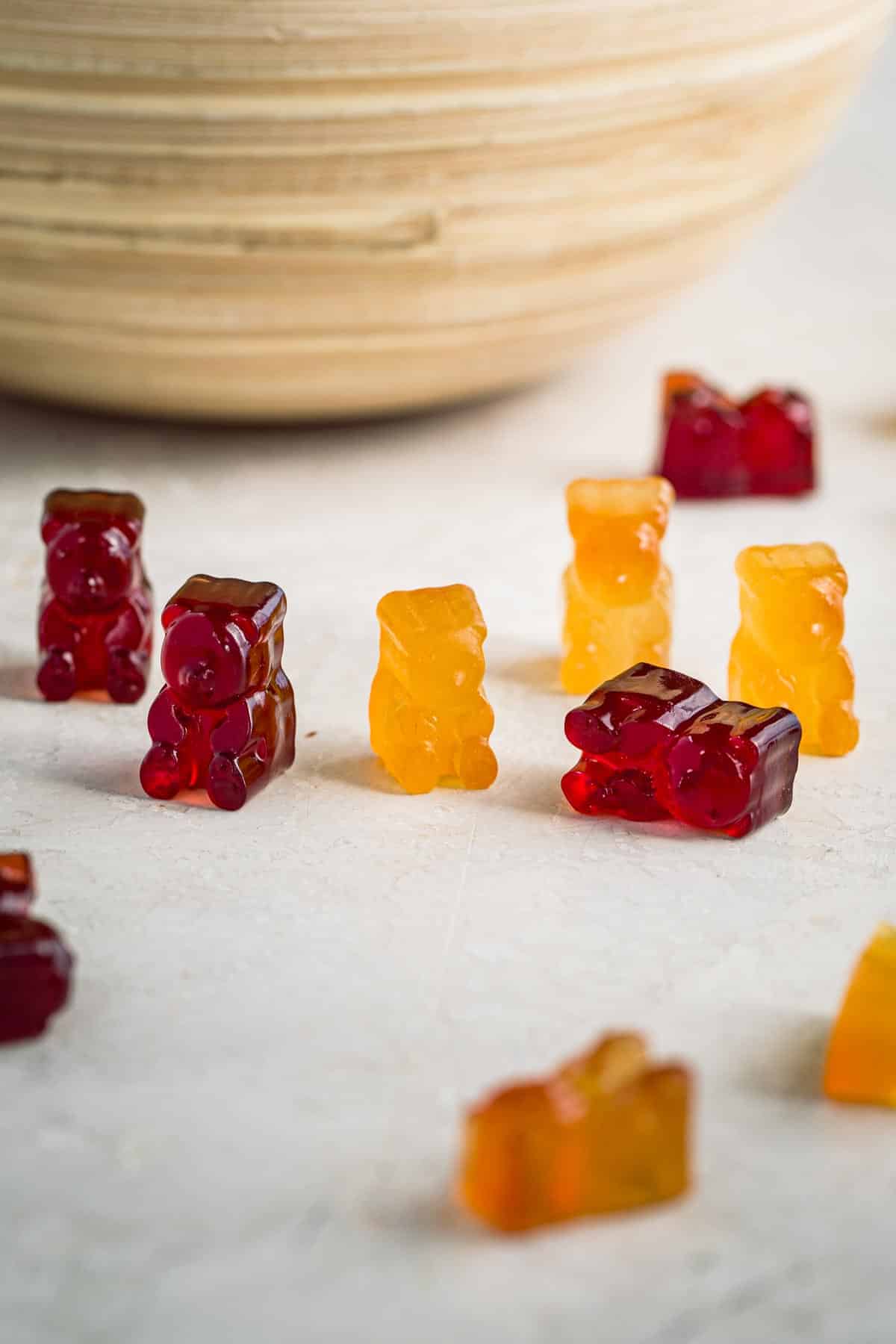 Homemade gummy bears on a table. Some standing up and some sideways.