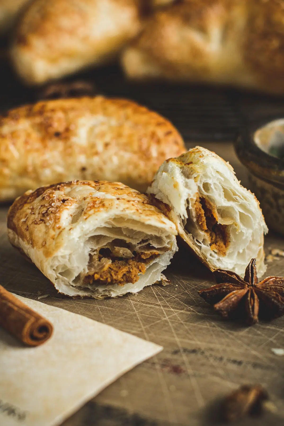 Harry Potter pumpkin pastie torn in half on a wooden table.