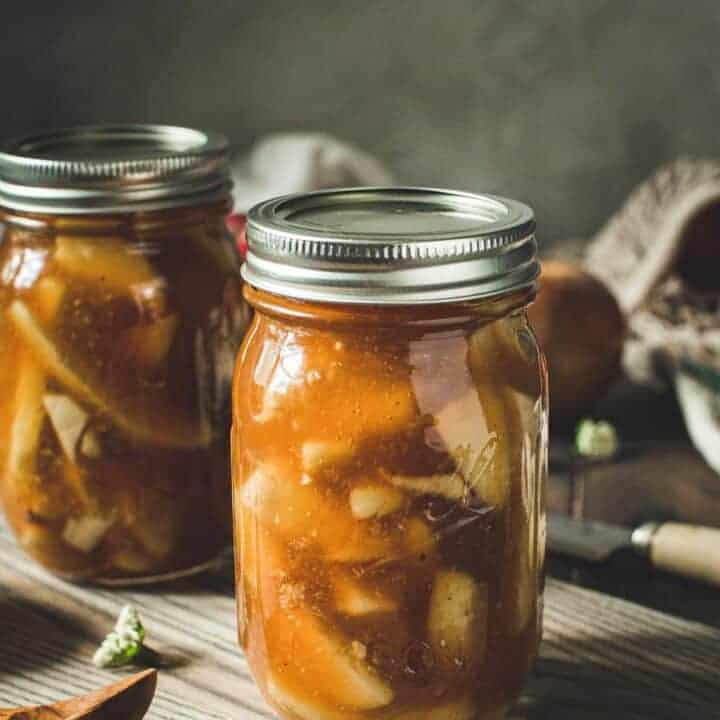 Homemade apple pie in a pint jar with lid.
