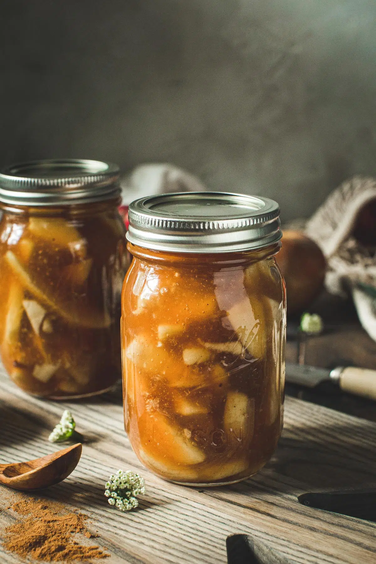 Homemade apple pie in a pint jar with lid.