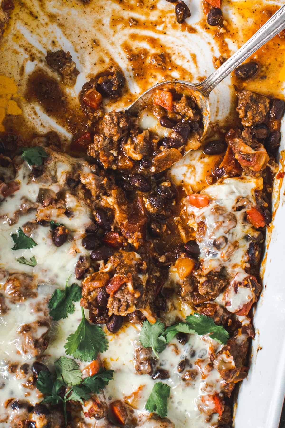 Mexican ground beef casserole in a white casserole dish.