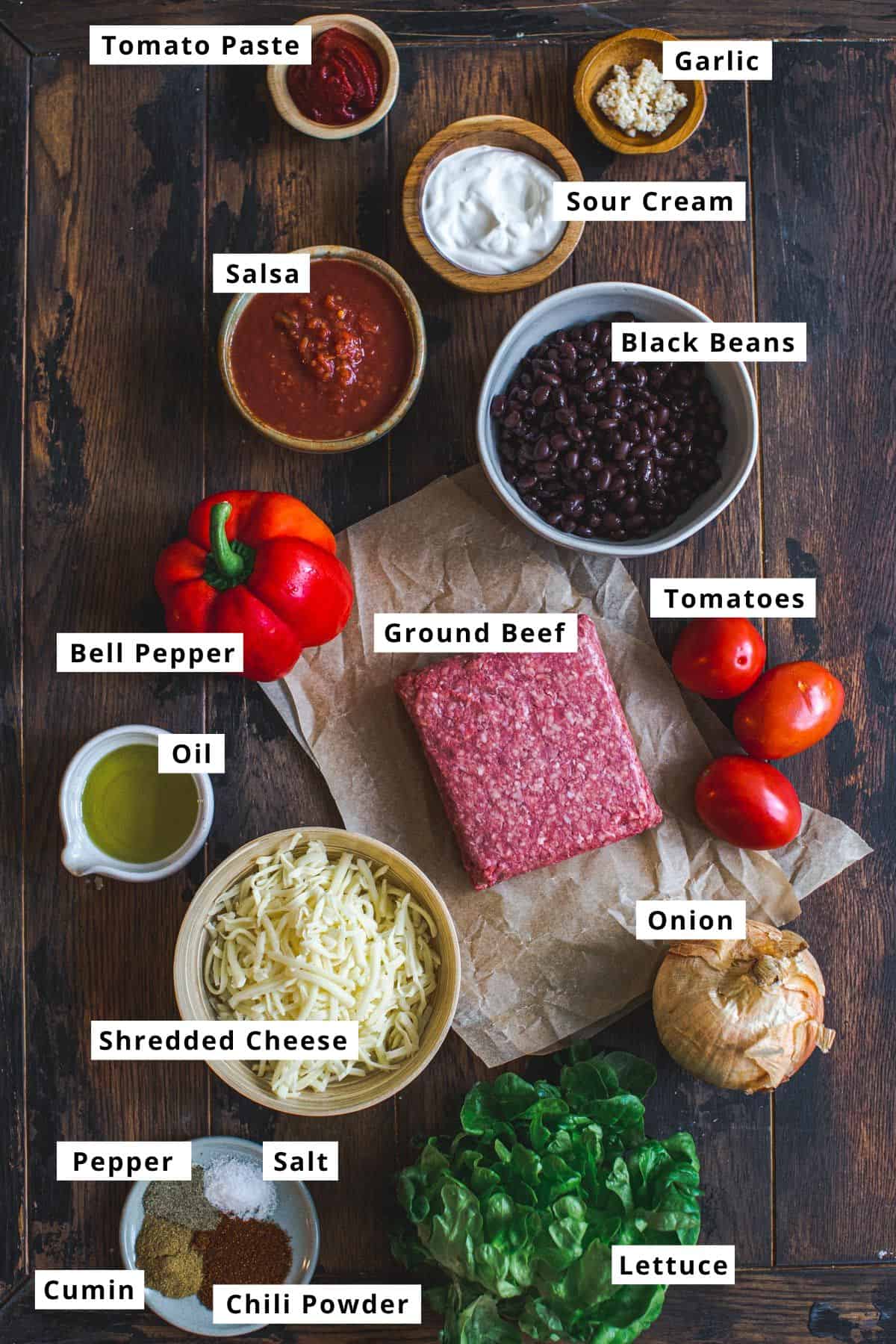 Mexican ground beef casserole ingredients in various bowls.