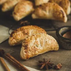 Harry Potter pumpkin pasties on a wooden table.