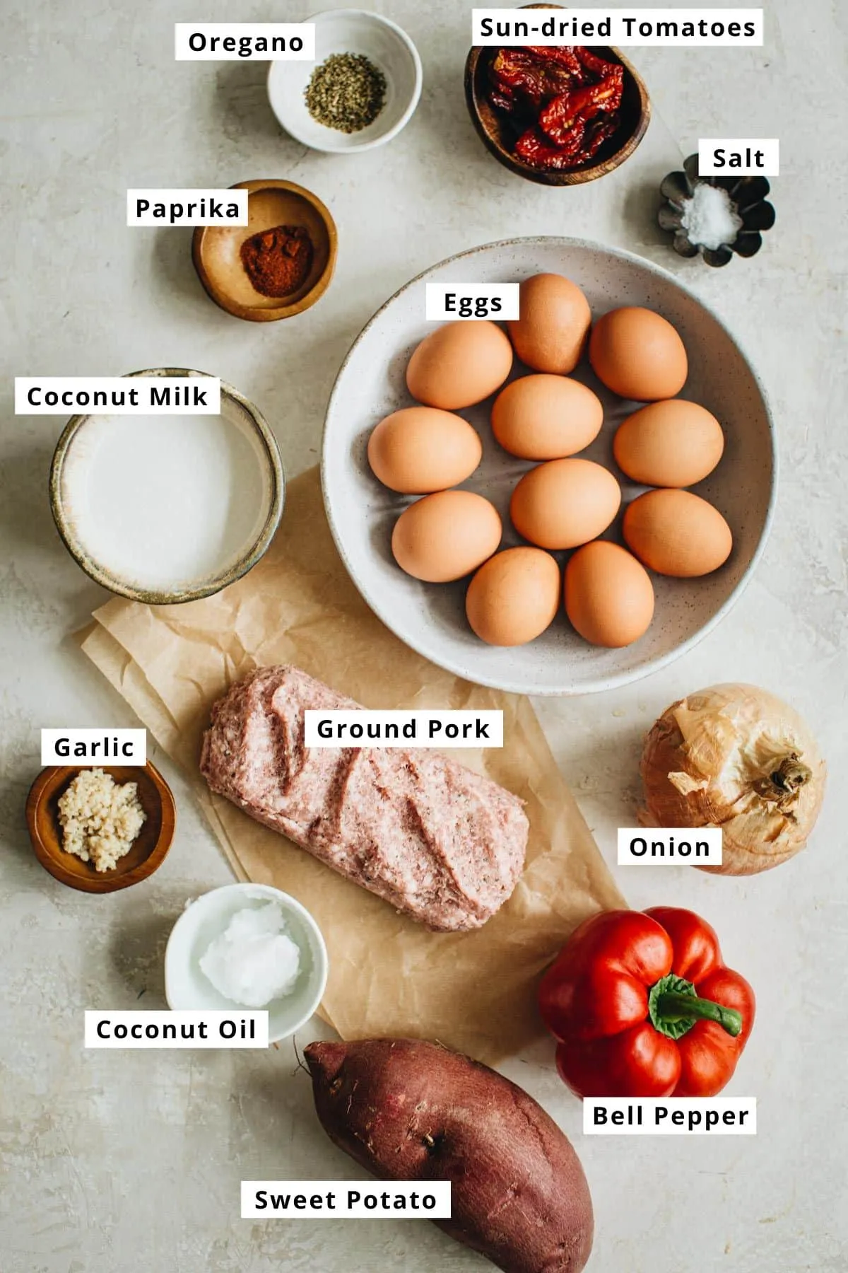 Sausage and egg casserole ingredients in various bowls.