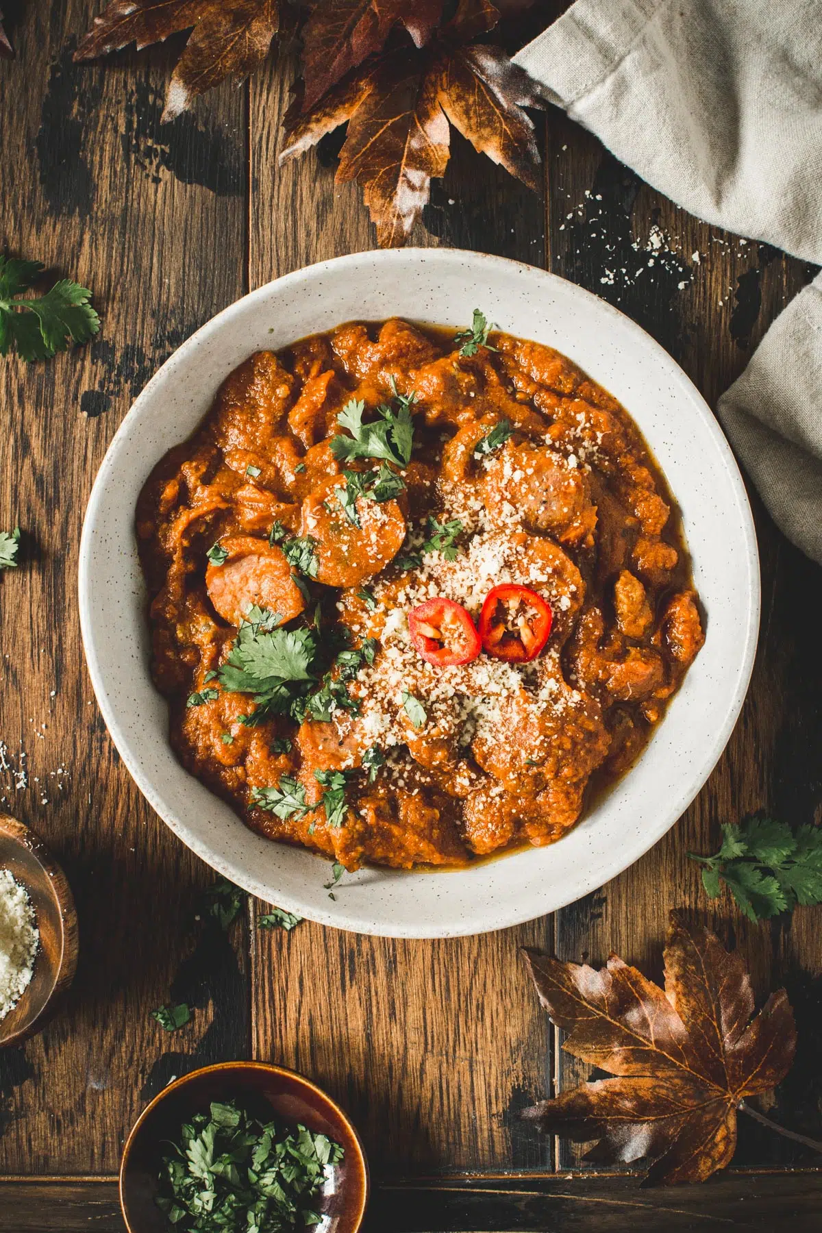 Pumpkin chili in a bowl topped with parmesan cheese.