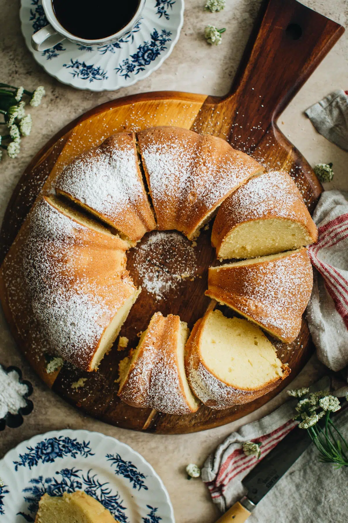 Sour cream pound cake sliced on a wooden board.