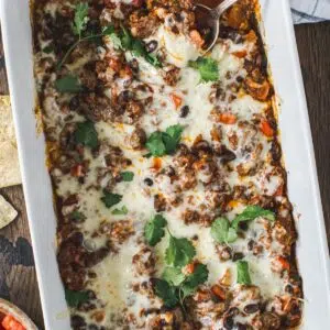 Mexican ground beef casserole in a white casserole dish.