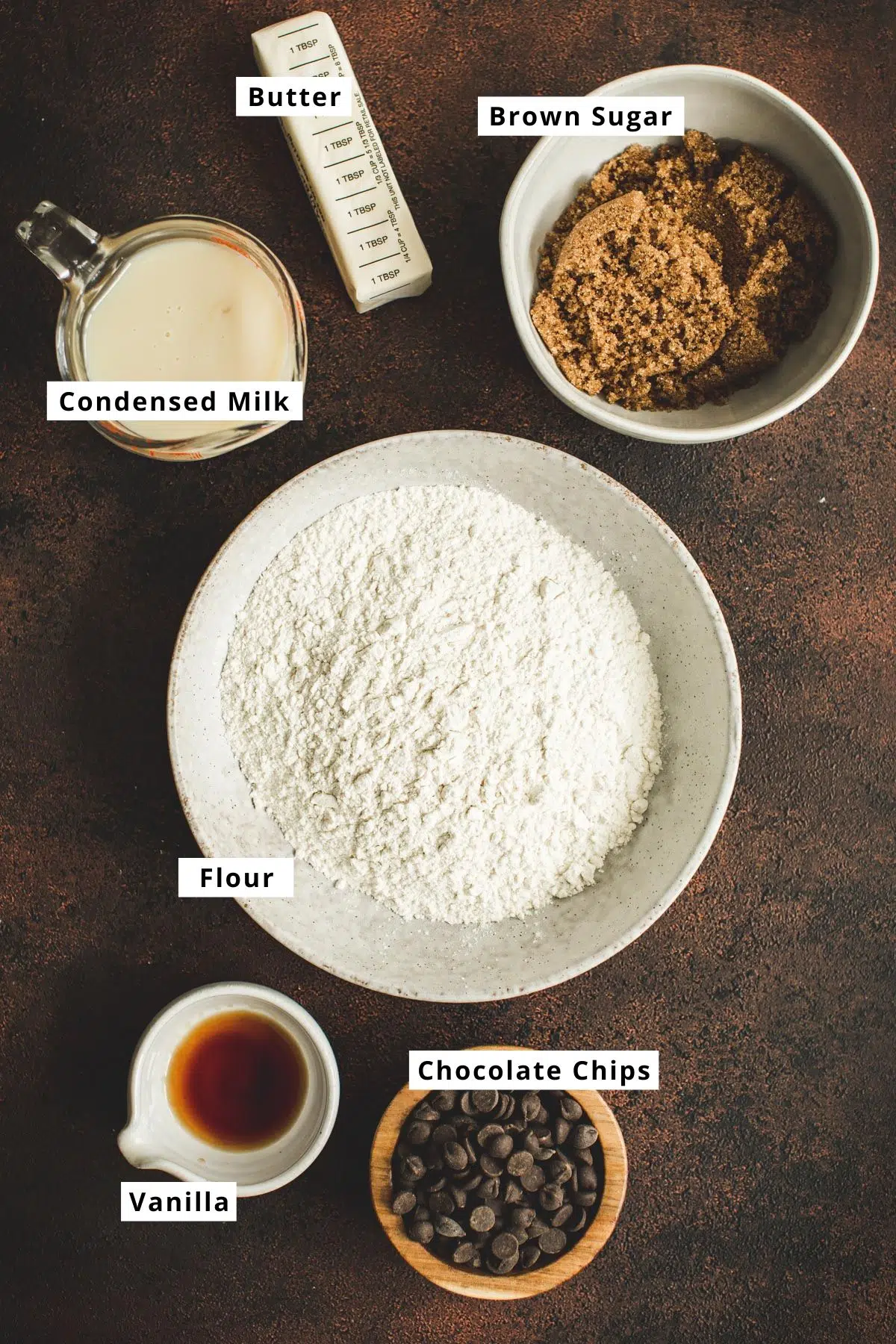 Cookie dough bars recipe ingredients in various bowls.