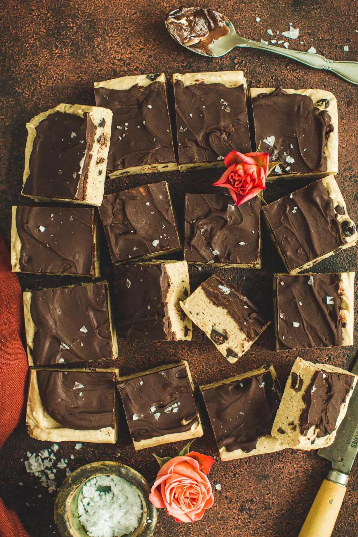 Cookie dough bars cut into squares with chocolate on top.