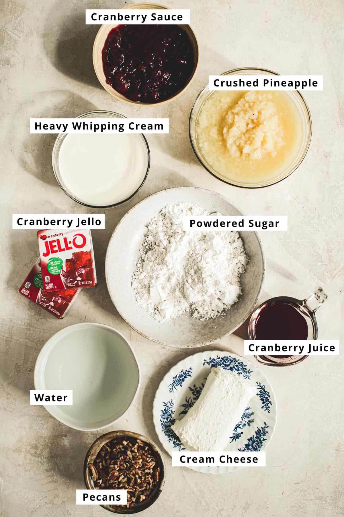 Cranberry jello salad ingredients in various bowls.