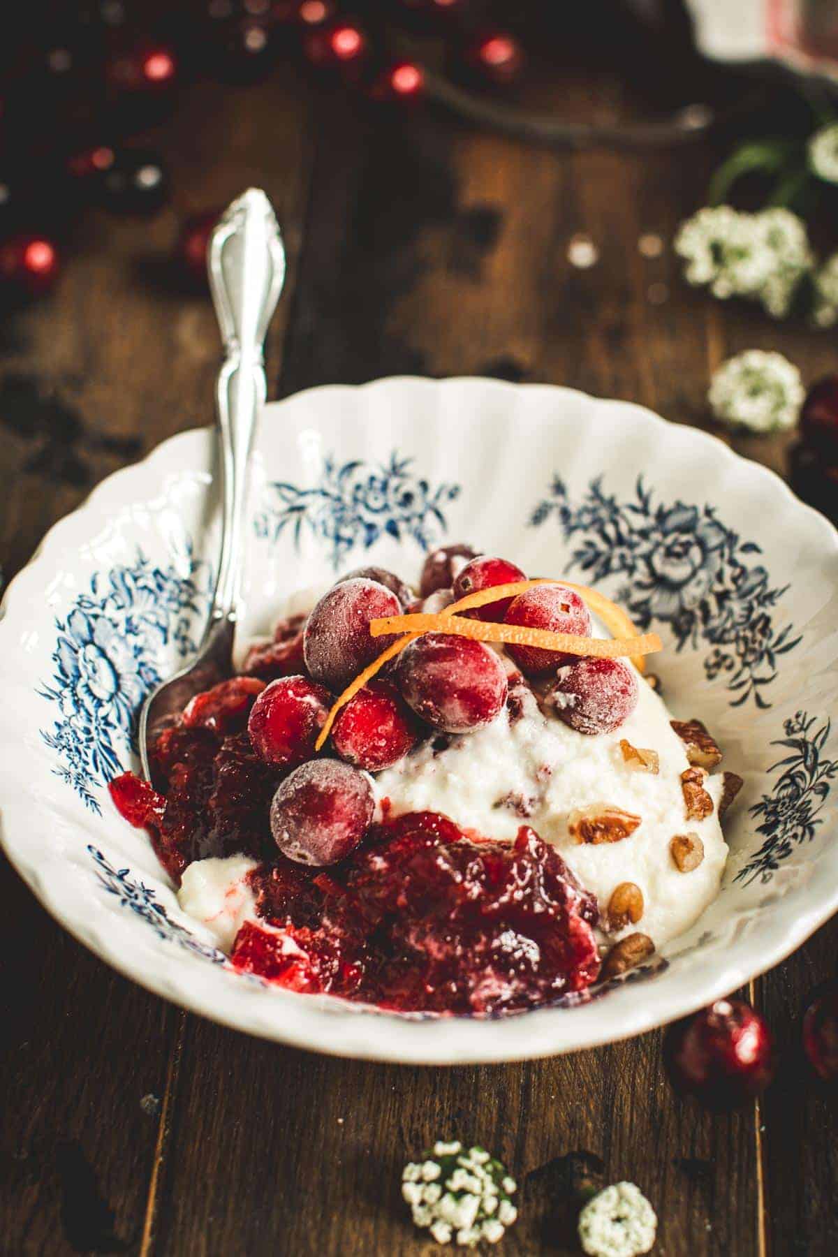 Cranberry jello salad with cream cheese in a blue and white bowl.