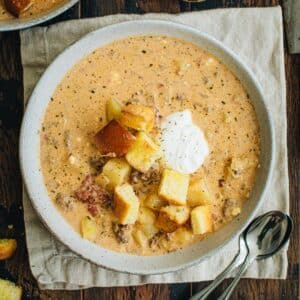 Crockpot Cheeseburger soup topped with hamburger bun croutons.