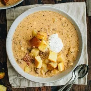 Crockpot Cheeseburger soup topped with hamburger bun croutons.