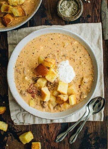 Crockpot Cheeseburger soup topped with hamburger bun croutons.