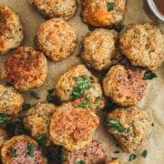Sausage and cheese balls with chopped parsley on top.