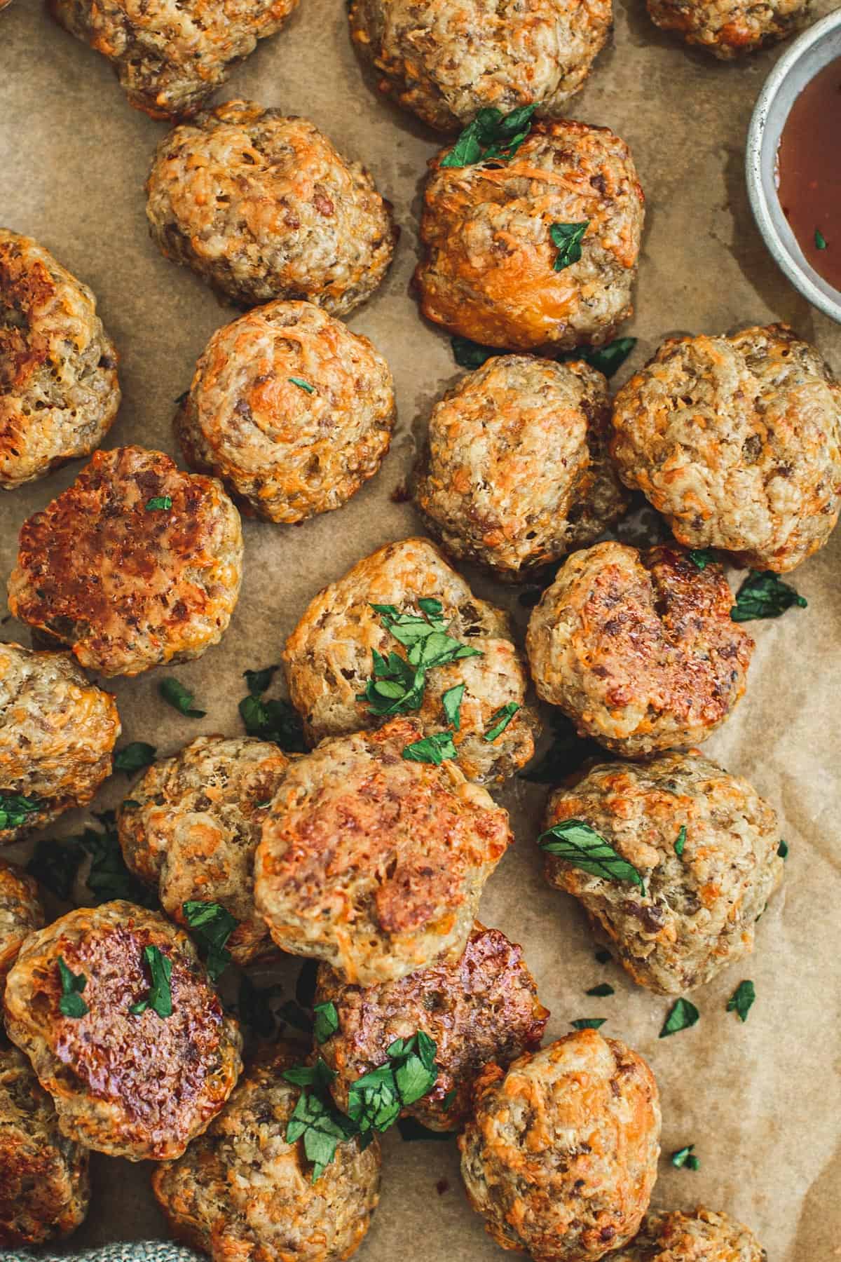 Sausage and cheese balls with chopped parsley on top.