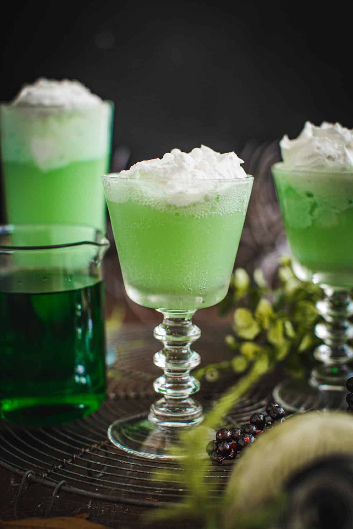 Polyjuice potion in a glass topped with whipped cream.