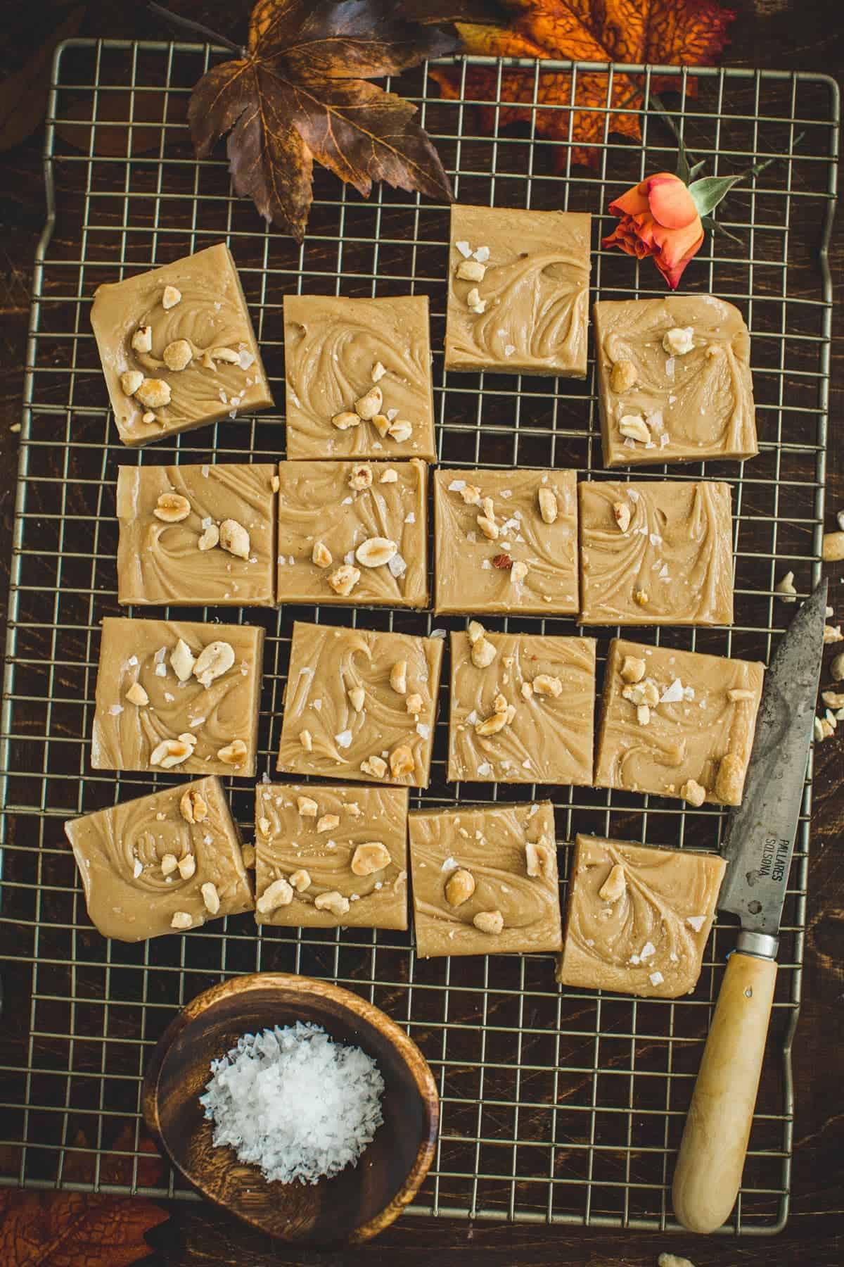 Sliced homemade peanut butter fudge on a wire rack.