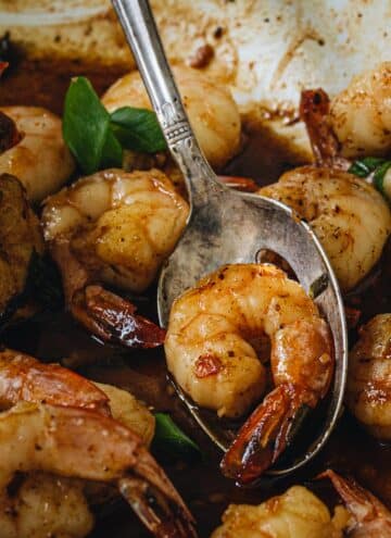 Cajun shrimp on a silver serving spoon.