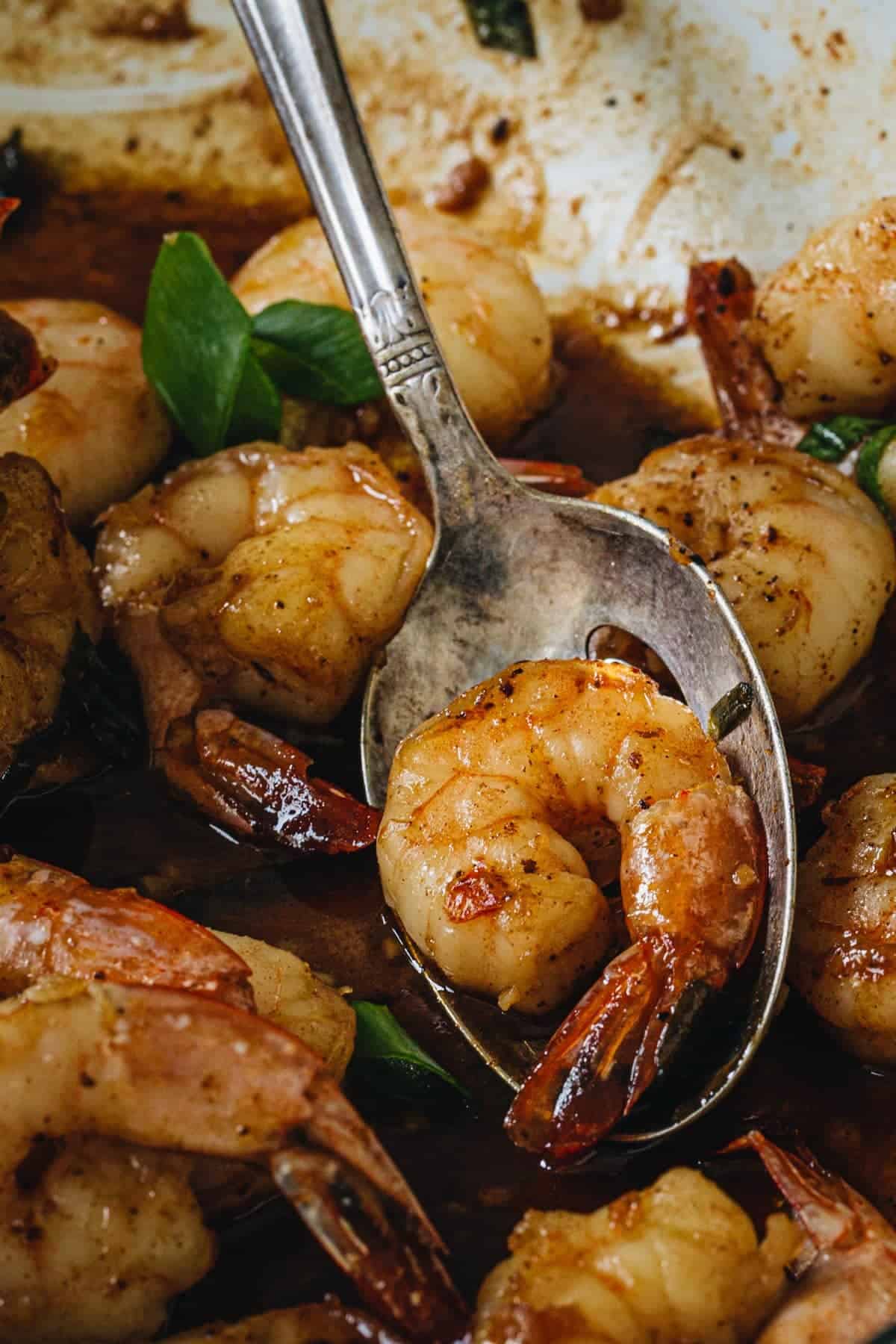 New Orleans shrimp on a silver serving spoon.